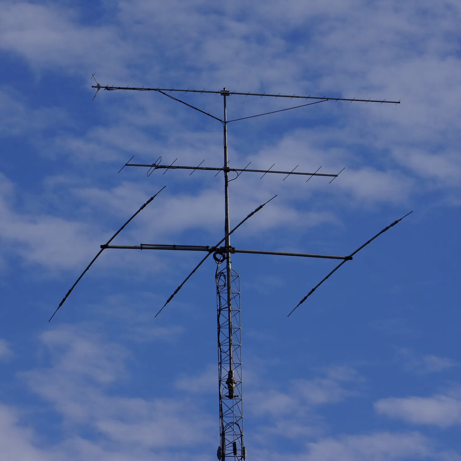 Amateur radio beam antenna on a lattice tower against a blue sky