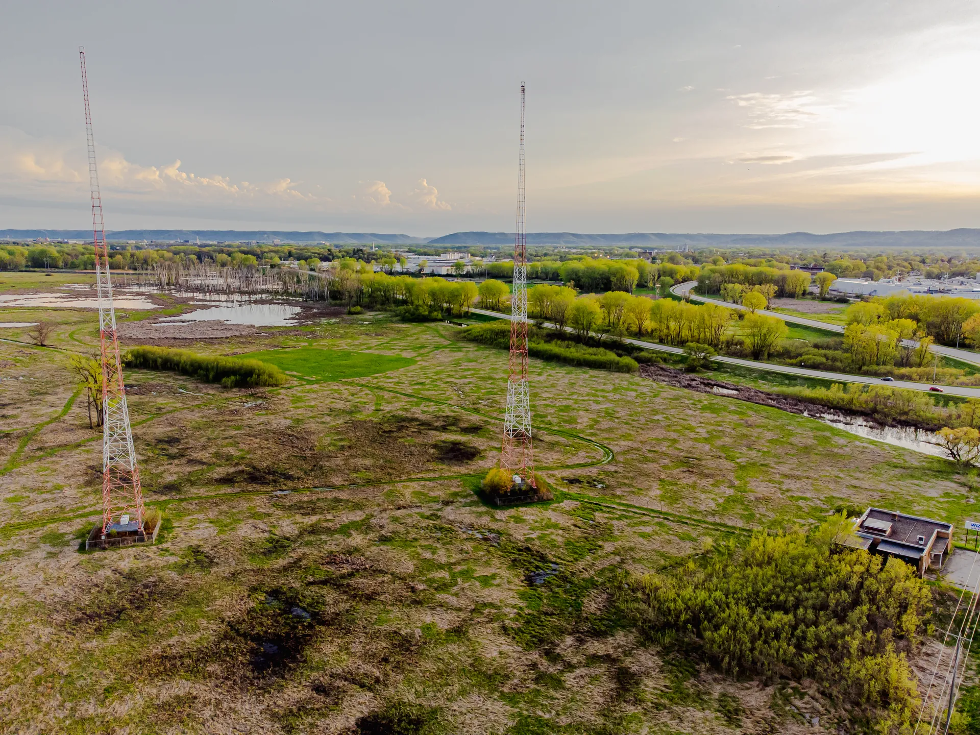 Two guyed radio towers on open marshland in La Crosse, Wisconsin